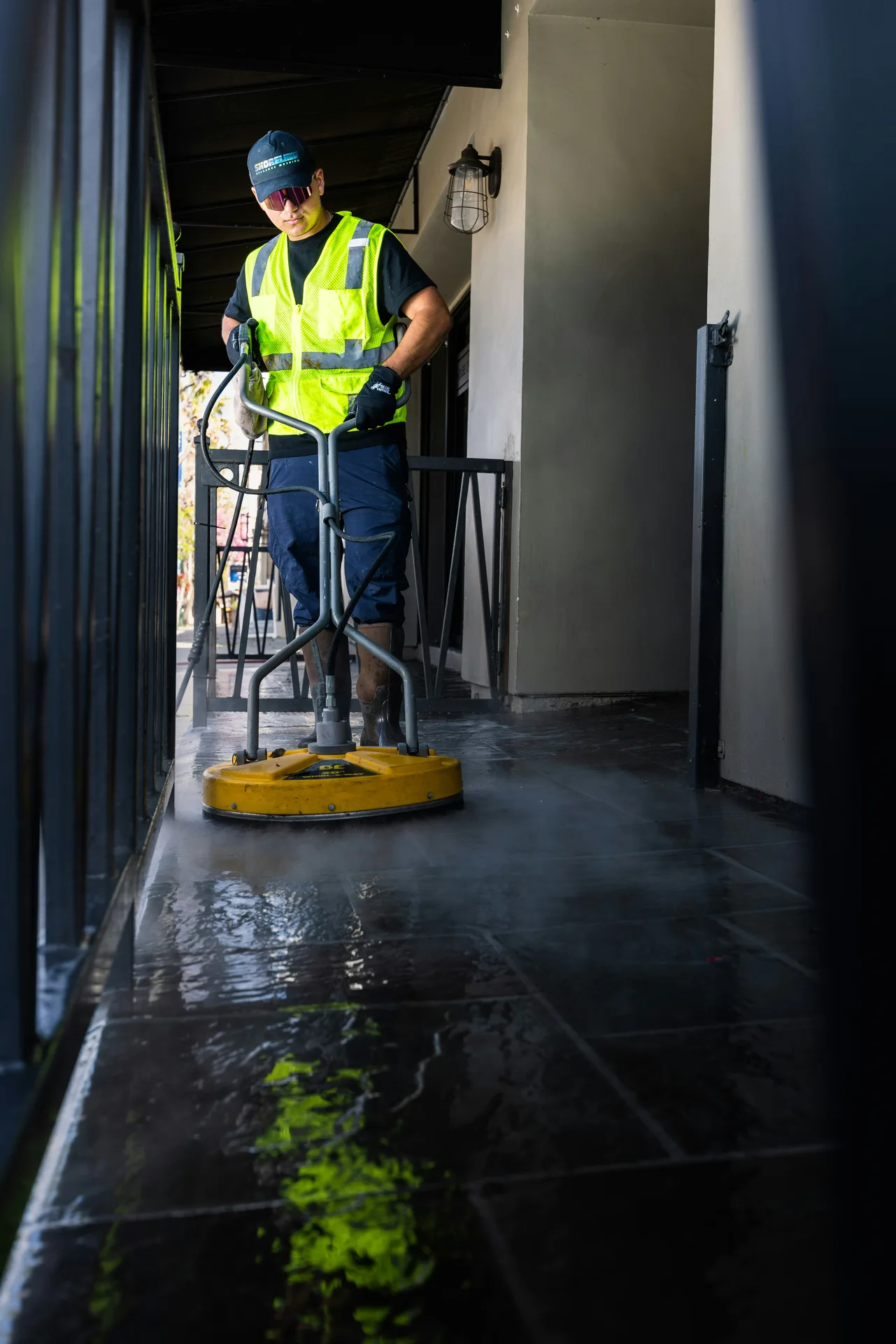 Technician Using Surface Cleaner on /oil-stain-removal/ — Calgary Pressure Washing Calgary